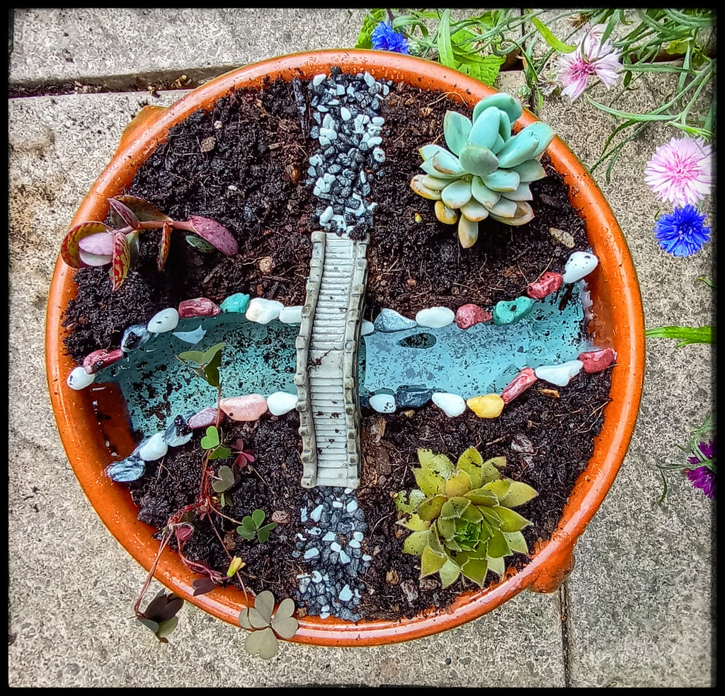 Miniature garden with bridge and stream